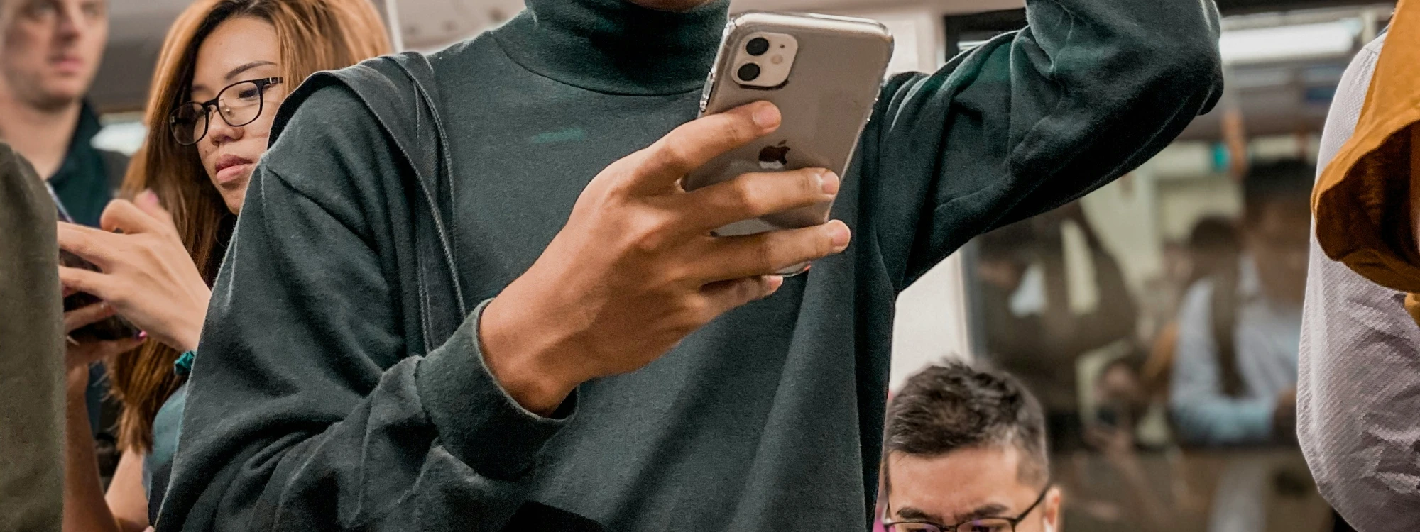 Holding a phone on subway