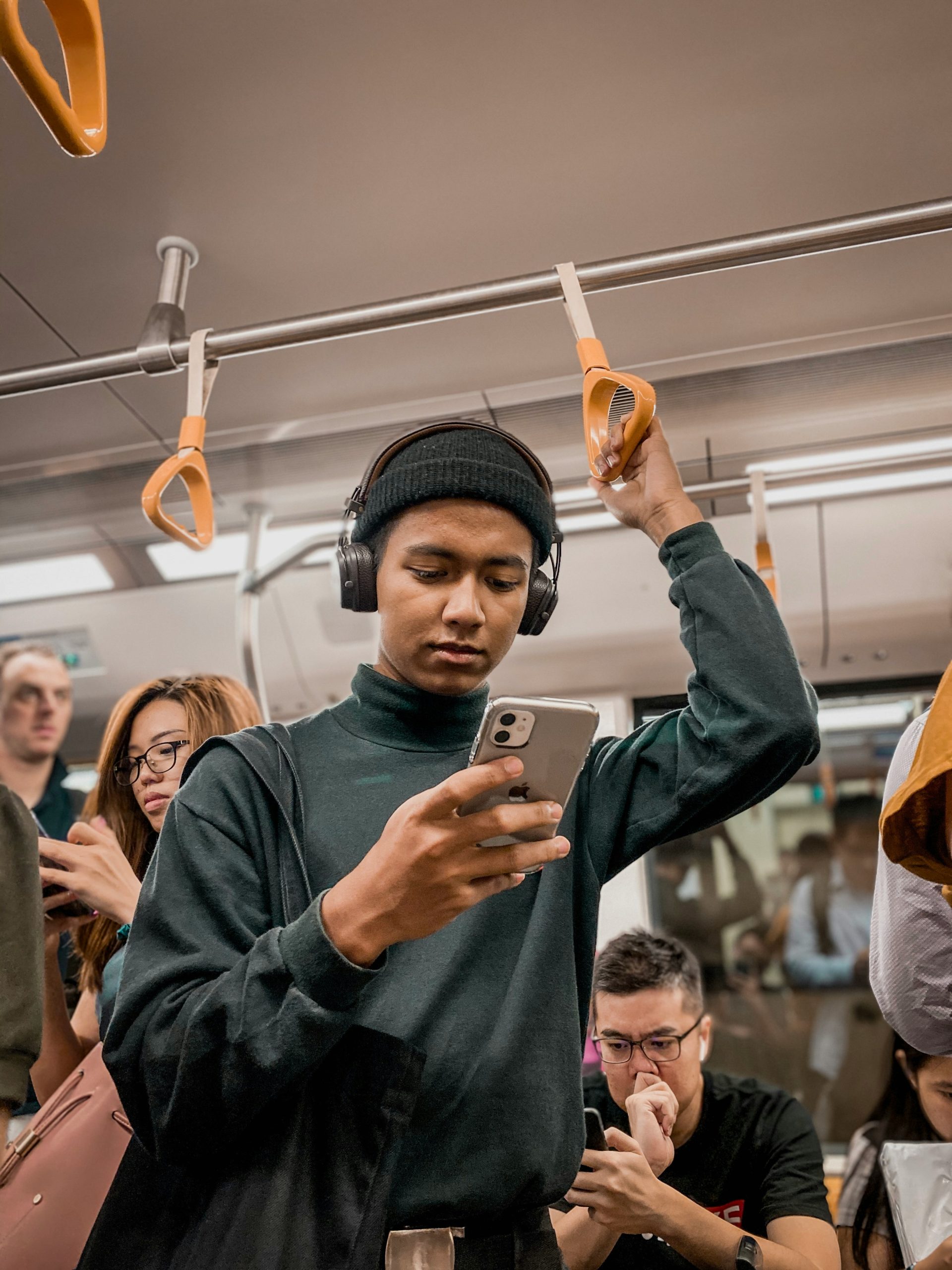 A man holding a phone on a train