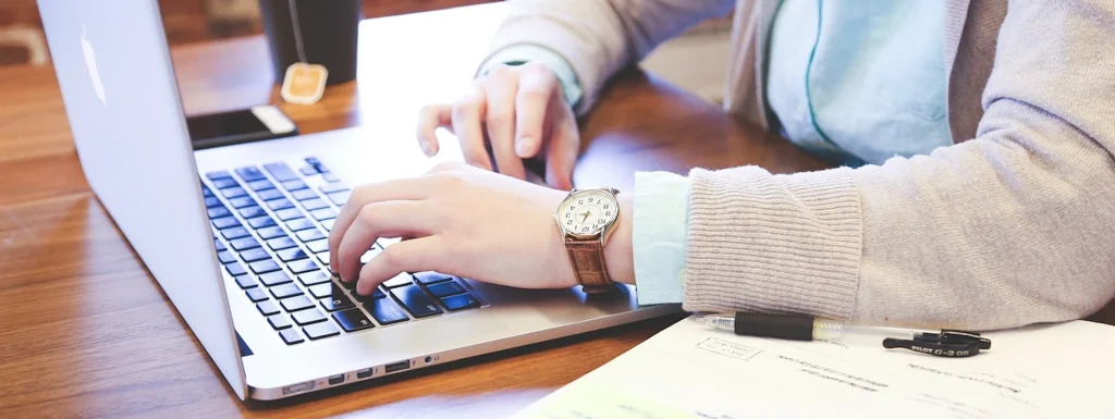 A person typing on a laptop
